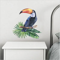 Adhésif Mural à Design de Toucan sur une Branche sur fond gris avec un meuble dessous