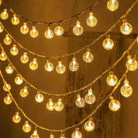 Guirlande Boule Lumineuse à LED Effet Boule de Noël suspendue avec un mur en fond