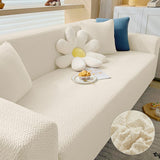 Housse Canapé Extensible et Etanche en Polyester sur un canapé avec des coussins