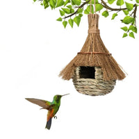 Nichoir Tissé à la Main en Forme de Maison en Bois sur fond blanc avec une branche et un oiseau en dessous