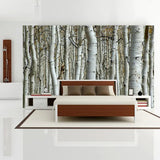 Revêtement Mural Etanche avec Design de Forêt de Bouleaux sur un mur avec un lit et sol blanc
