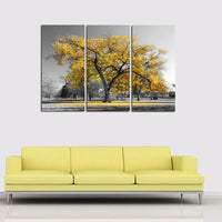 Tableau Décoratif Mural en Toile au Design d'un Arbre Jaune sur fond gris avec un canapé jaune